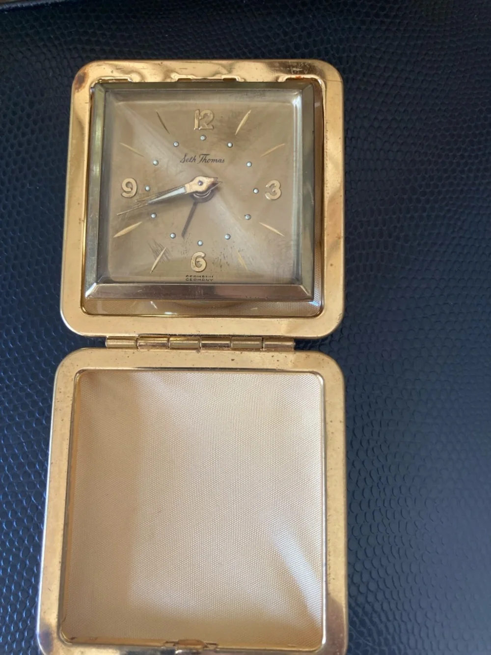 Classic mid-century Seth Thomas folding travel alarm clock in gold-tone texture
